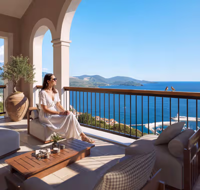 Woman overlooking the Montenegro coast from a stone balcony